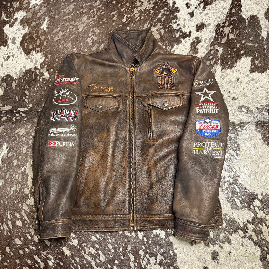 Brown Vintage Mirage NFR Jacket with various patches on a western cowhide background