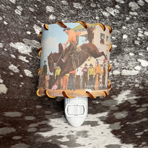 Decorative night light with horse and rider design on a textured surface