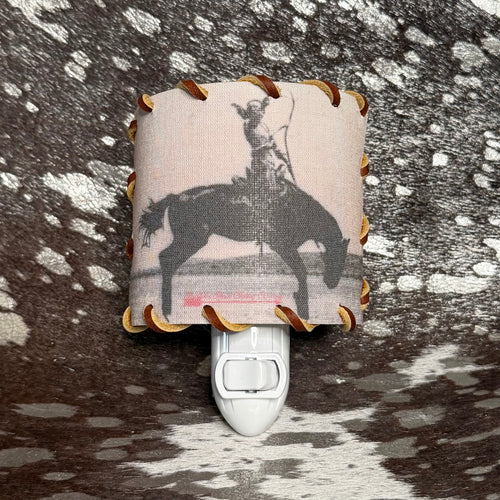 Decorative night light with horse and rider design on a textured surface